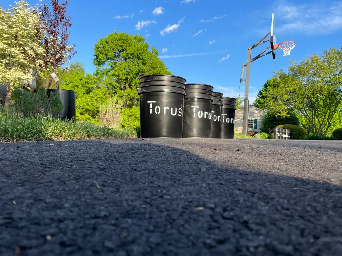 A row of Torus compost buckets lined up, representing scraps pooled by a neighborhood.