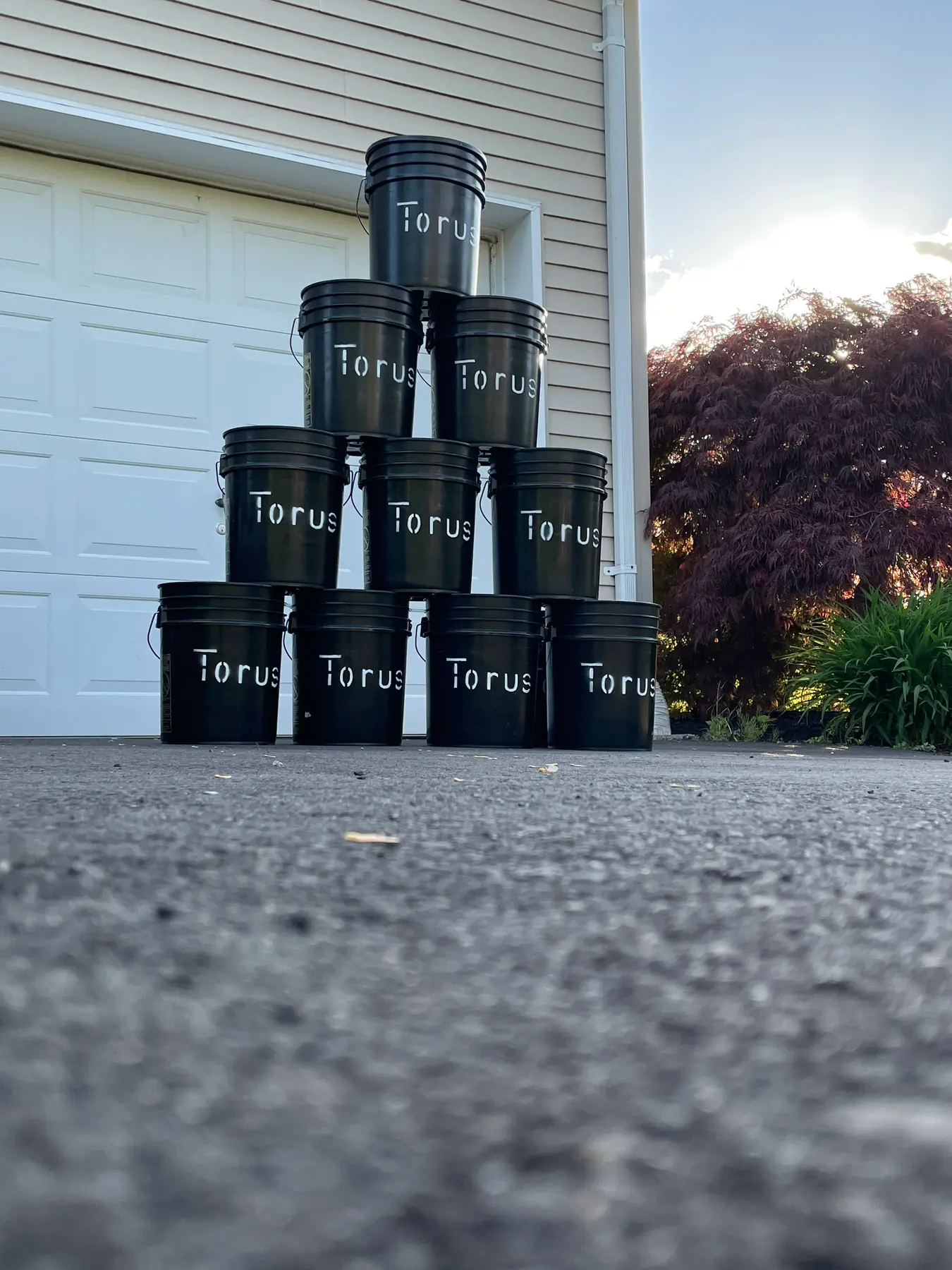 Torus compost buckets stacked and staged for collection at scale, as used by businesses and restaurants.