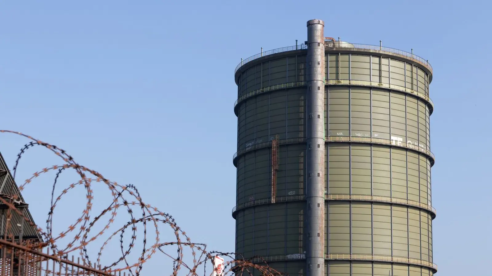 A large industrial gas-holder tank used to capture biogas from anaerobic digestion.
