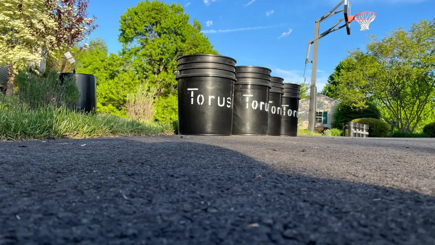 A row of Torus compost buckets lined up, illustrating sorting organics from other waste streams.