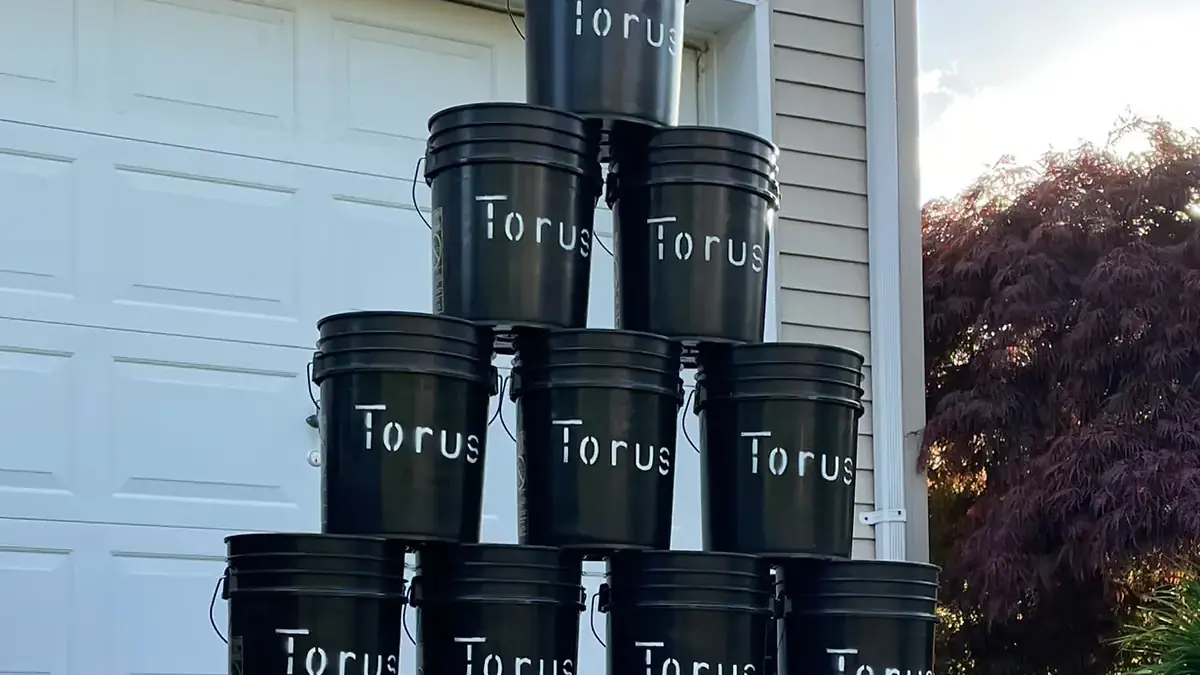 A pile of collected Torus compost buckets staged after pickup, before heading to the processing facility.
