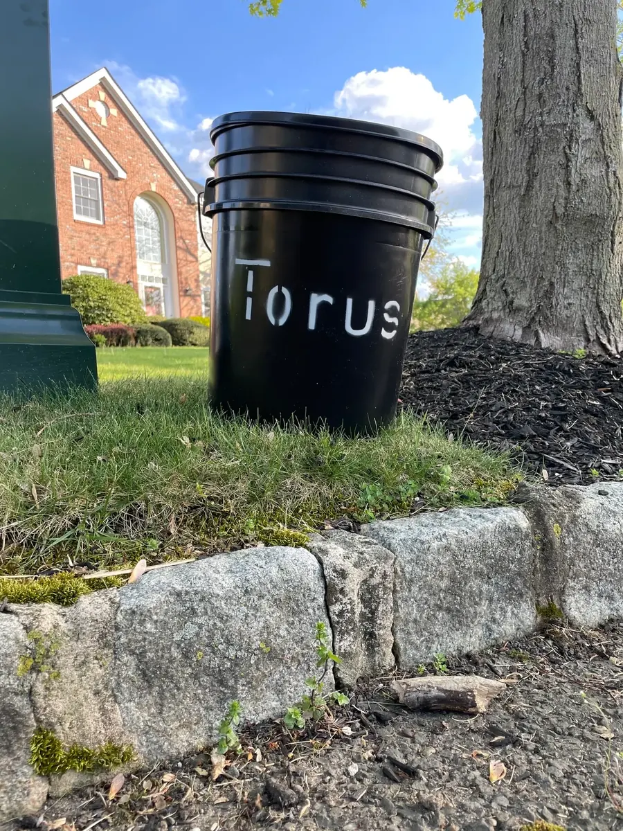 Torus compost bucket set out beside a home for free curbside pickup